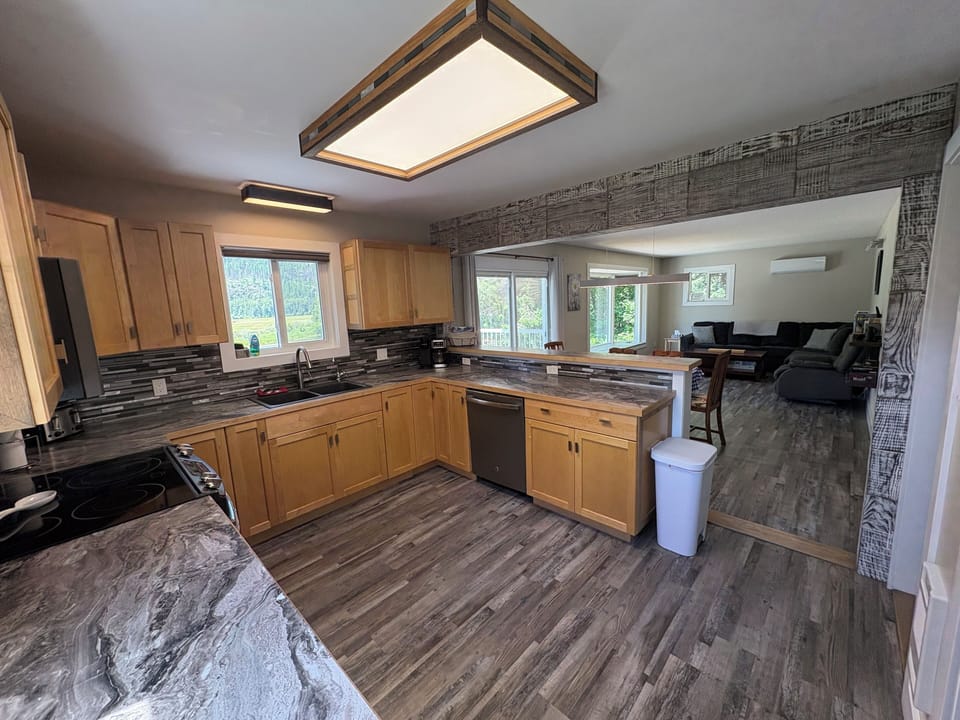 Full kitchen with modern appliances and open flow for meals together.