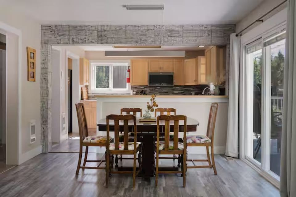 Dining for six with open flow to kitchen and deck for easy gatherings.