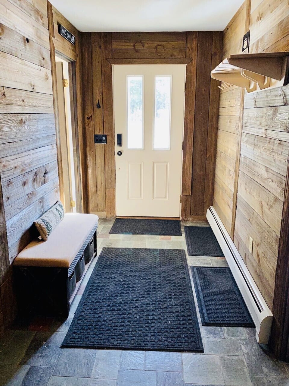 Large entry way with custom shelf to hold your skis, poles, and helmets.