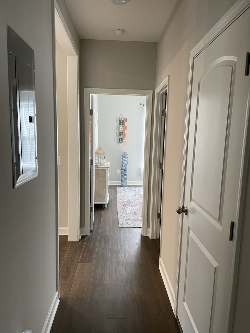 Hallway between master bedroom and bedroom 2. Laundry and bathroom on the right.