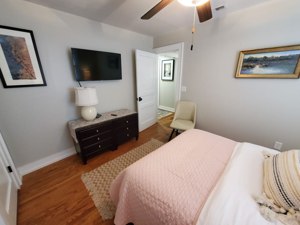 Pink bedroom has a Roku TV for all your streaming needs