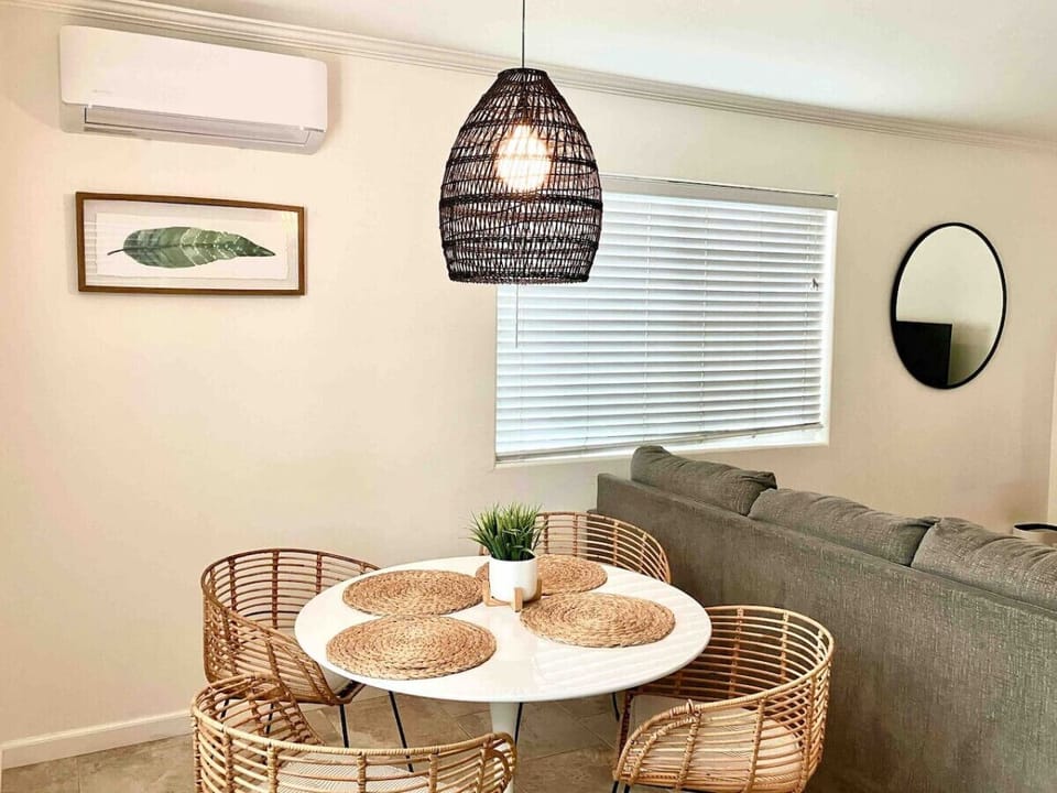 Living room has a comfy sofa, ceiling fans and TV with cable. Dining table seats 4 and one Mini Split AC unit (one unit for the whole cottage).