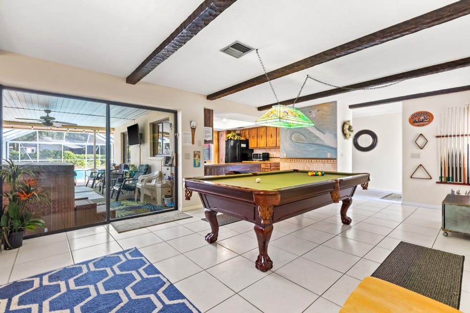 Pool table in game room adjacent to kitchen and outdoor patio!