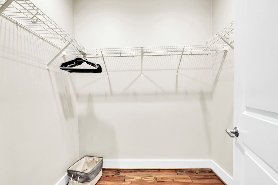 Your spacious walk-in closet offers organized wire shelving and warm wood floors to keep your belongings perfectly arranged.