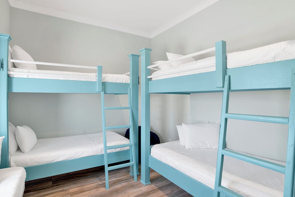 Guest bedroom with 2 sets of twin bunk beds and 1 single twin