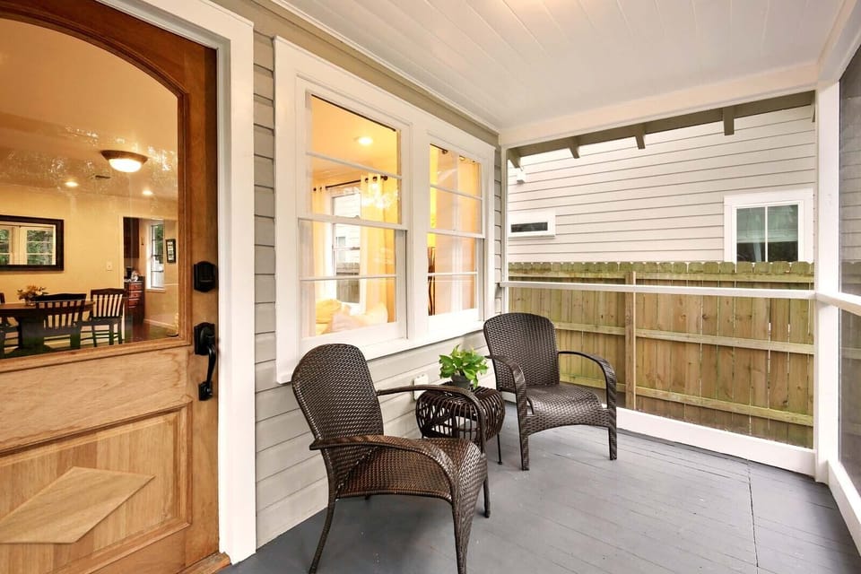 Screened front porch with view of historic Oak. 