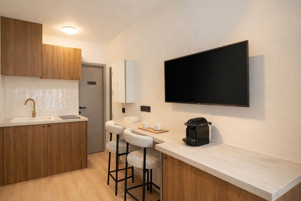 Cozy kitchenette stocked with utensils and appliances for a stress-free stay.