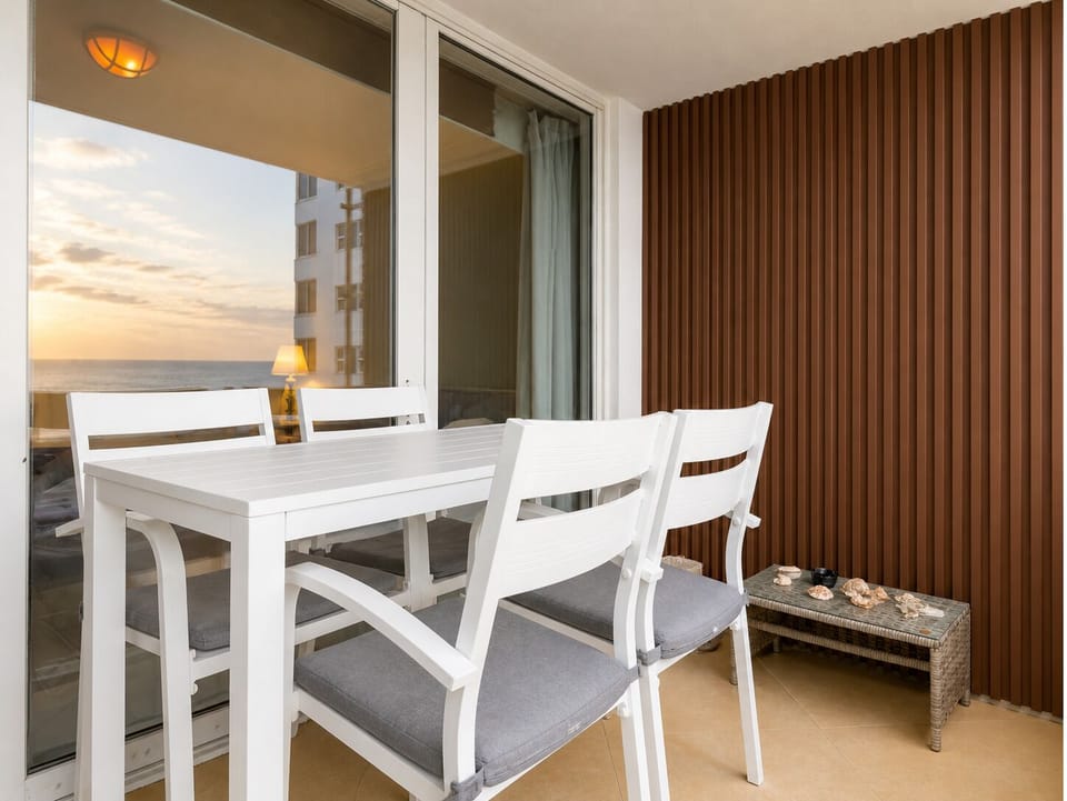 Private balcony with an outdoor dining table and chairs for al fresco meals.