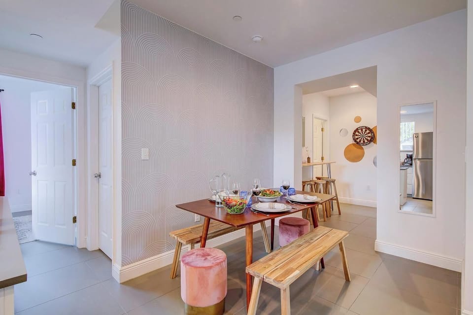 Apt 1: Dining room and wall mounted table at the back. 1st bedroom to the left. 