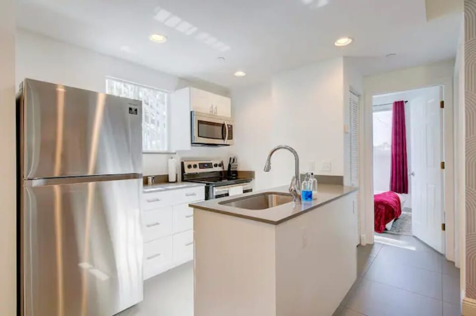 Apt 1: Fully equipped kitchen. To the right, you'll find the 1st bedroom. 