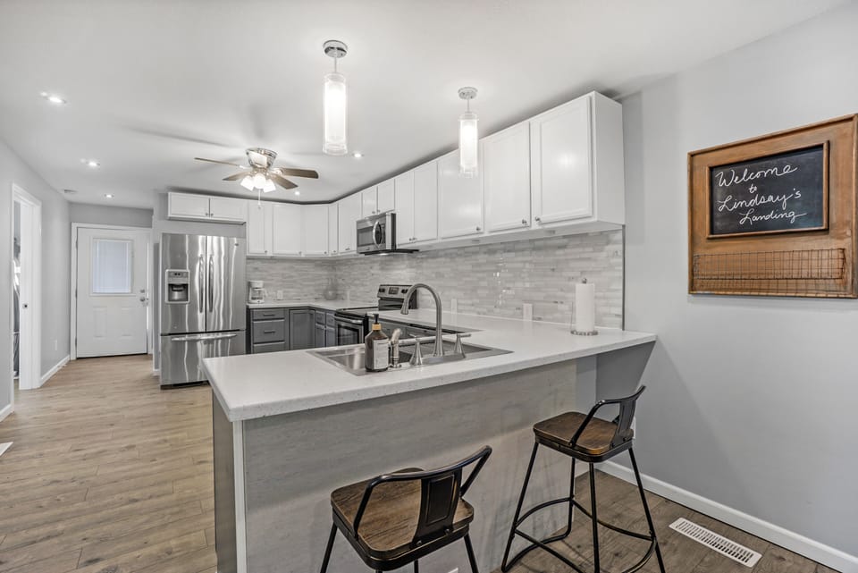 A kitchen with plenty of workspace and equipment.