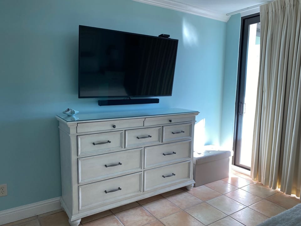 New 55" smart tv with bluetooth sound bar in primary bedroom