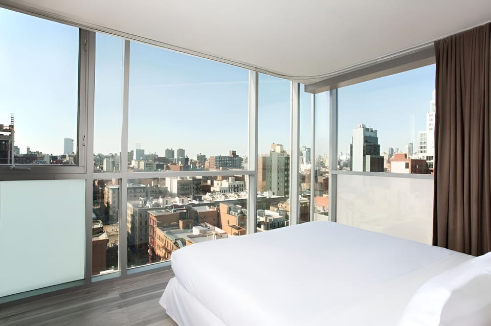 Wake up to sweeping skyline views from a cloud-soft bed.