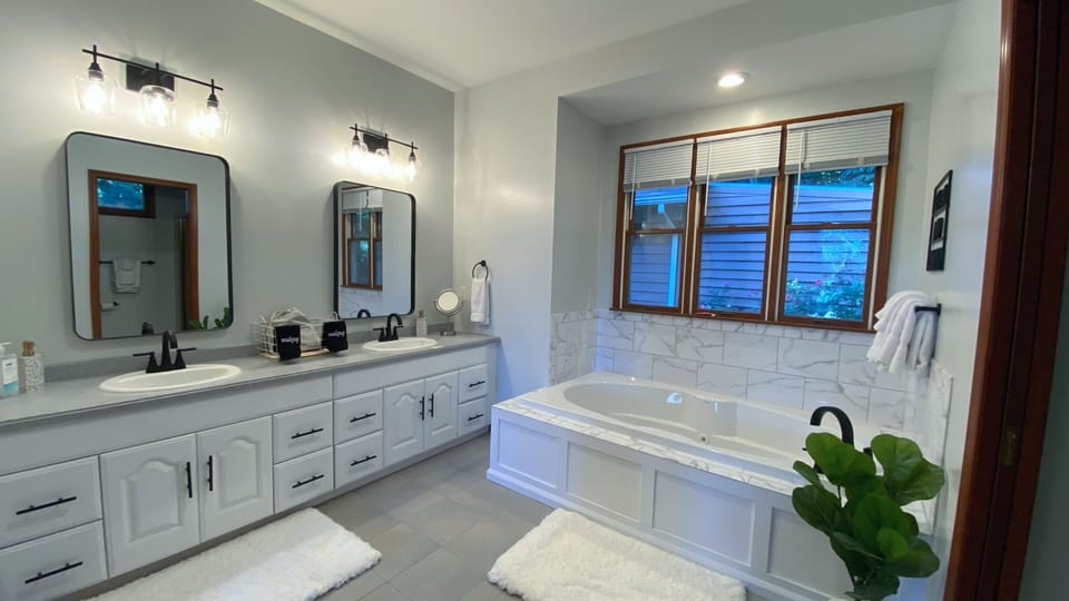 Master bathroom with double vanity and jacuzzi tub
