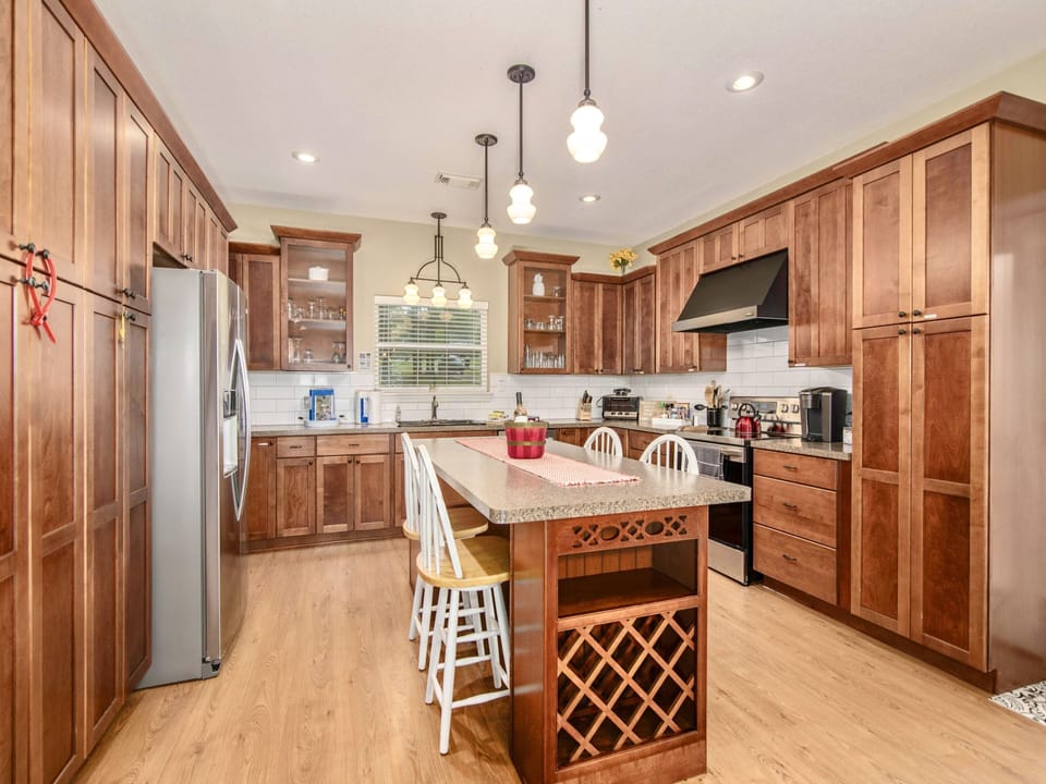 Chef’s kitchen with brand-new stainless steel refrigerator, dishwasher and oven 
