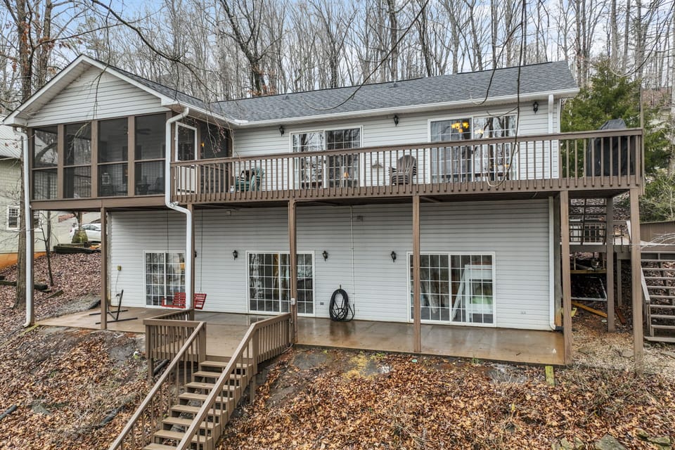 View of the back of the house, including the screened porch, deck, and patio