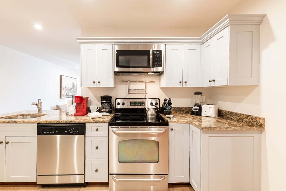 Open kitchen area with stainless steel appliances