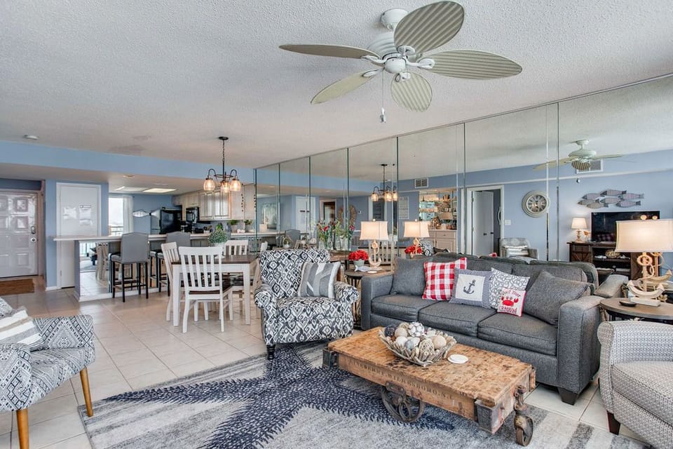 Living area with queen sofa sleeper and Gulf-view balcony access at Wind Drift