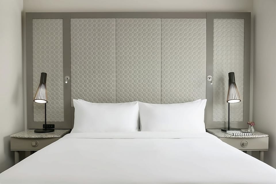 Drift off beneath soft pillows and warm bedside lighting.