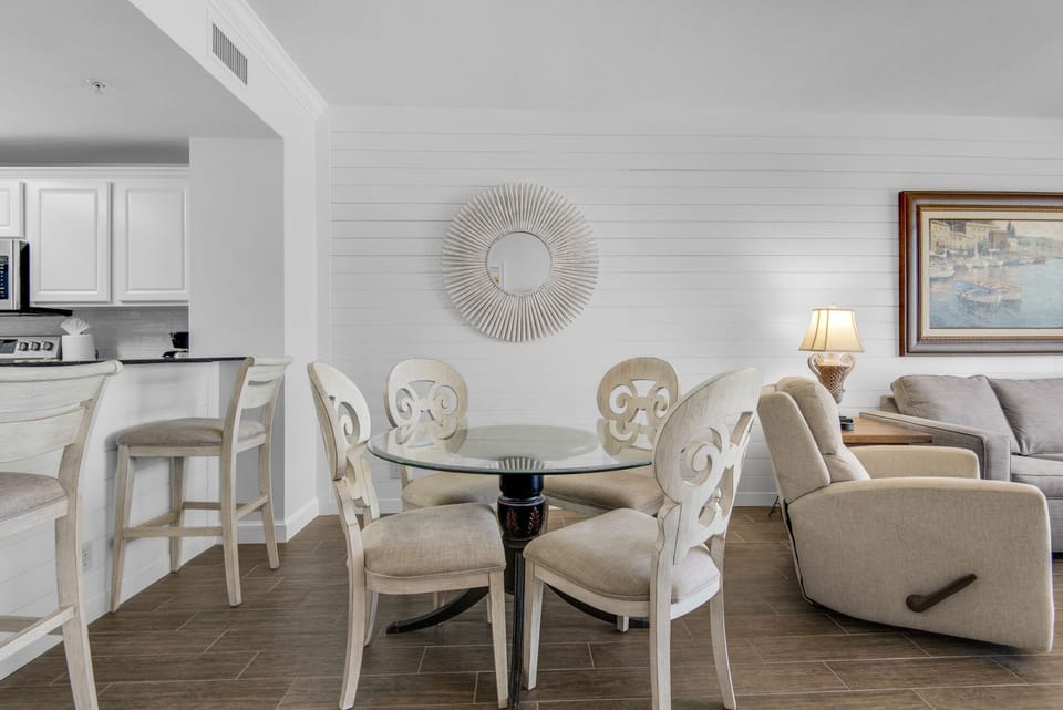 Dining Area - Gather in this stylish dining area with seating for four, perfect for savoring home-cooked meals while soaking in stunning beach views.