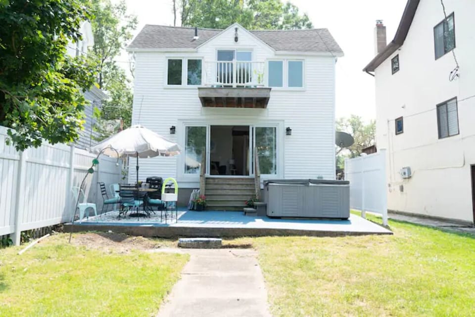 Back of the house, hot tub available for use on back patio. 