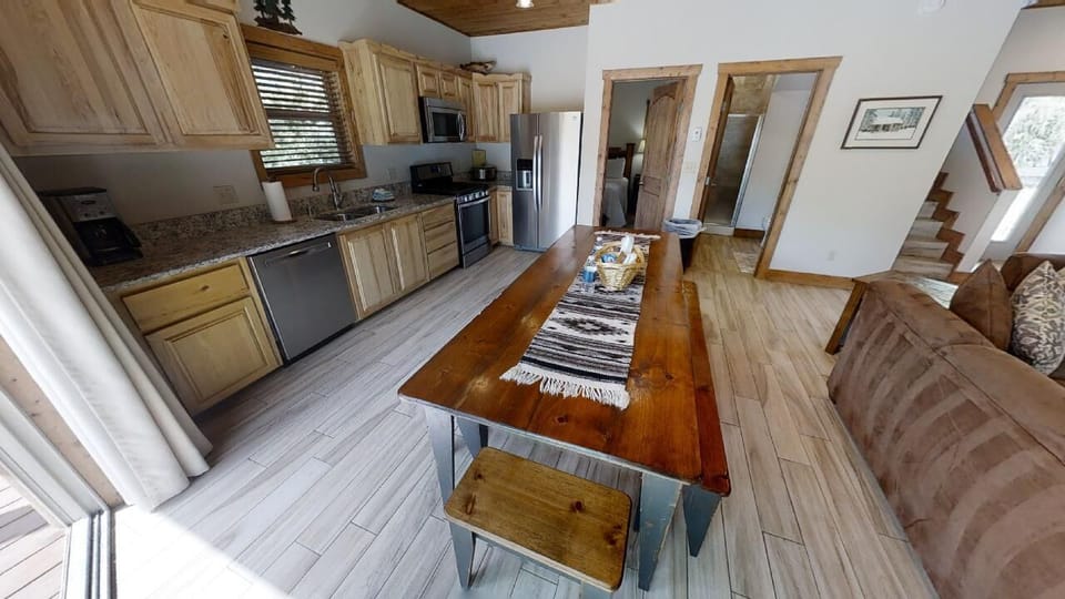 Step into your inviting open-concept retreat, where a fully-equipped kitchen flows seamlessly into the cozy living space—perfect for sharing meals and making memories together.