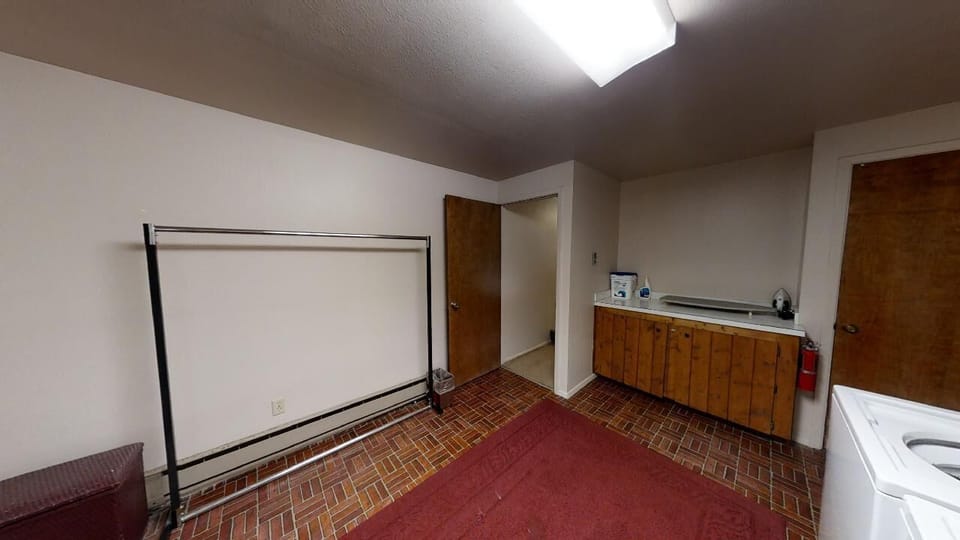 Your private laundry room features a dedicated washer, ample counter space, and convenient storage. The open layout and skylight make doing laundry feel less like a chore and more like a breeze.