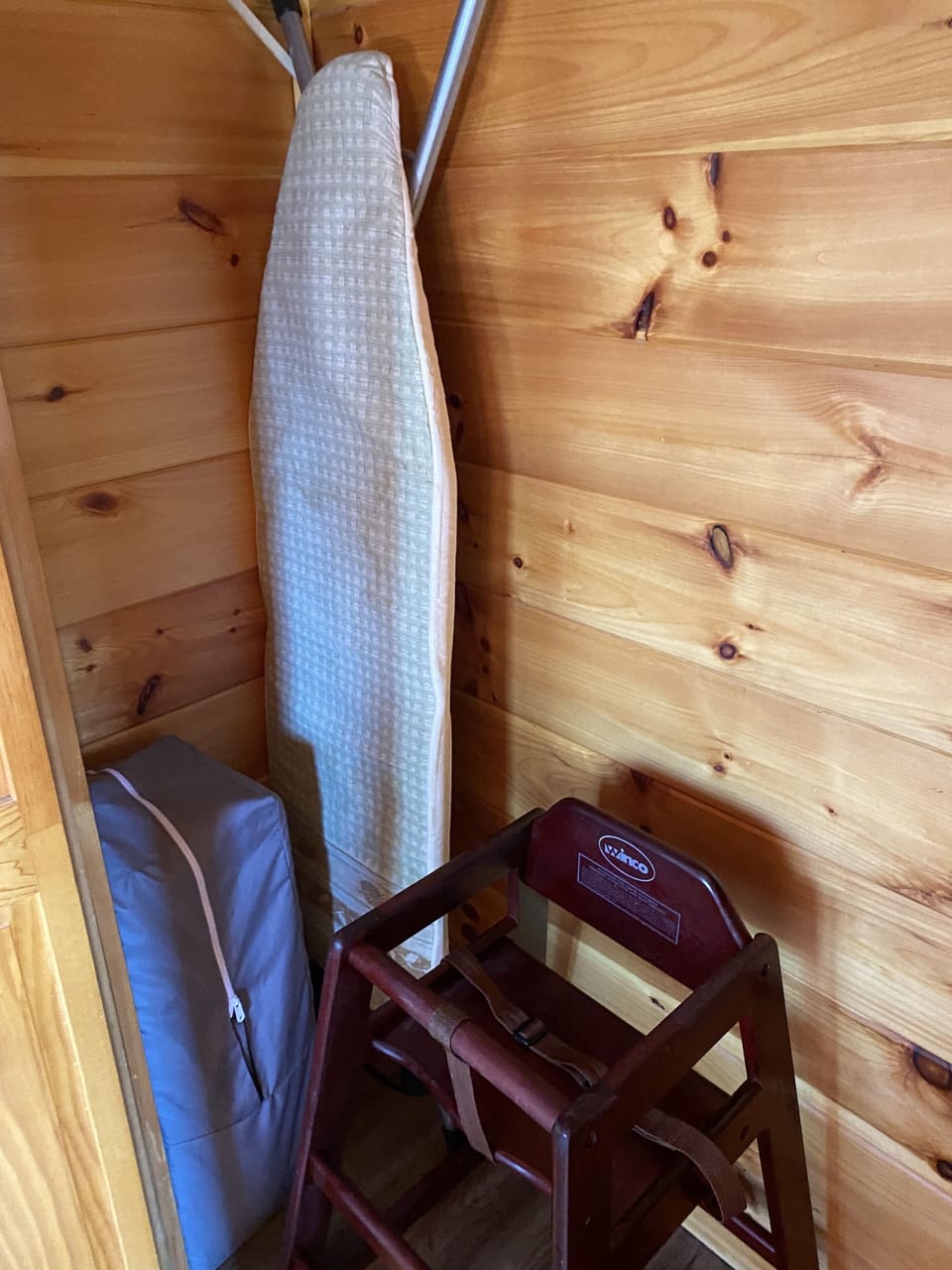 Pack 'n Play, high chair and ironing board in main level bedroom closet
