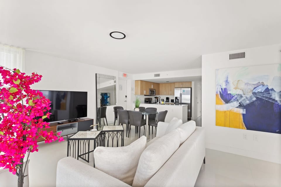 Spacious modern living room with Smart TV, dining area, and balcony at Bay Harbor Islands vacation rental near Miami Beach and Bal Harbor Shops