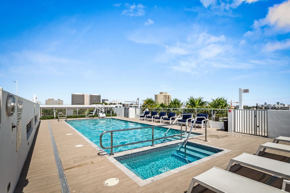 Rooftop pool and jacuzzi with lounge chairs at Bay Harbor Islands vacation rental near Bal Harbor Shops and Surfside Beach, perfect for family-friendly Miami getaways