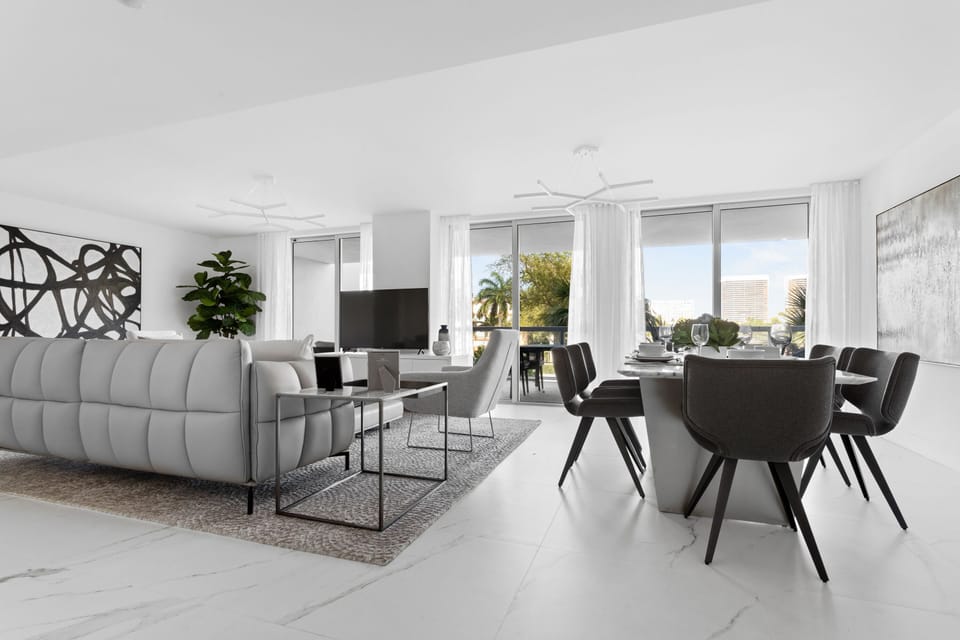 Spacious modern living room with Smart TV, dining area, and balcony at Bay Harbor Islands vacation rental near Miami Beach and Bal Harbor Shops