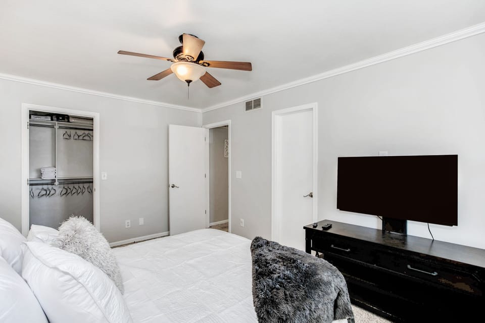 Master bedroom with smart tv and walk in closet 