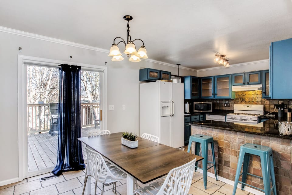Dining area with expandable table and extra chairs and barstools
