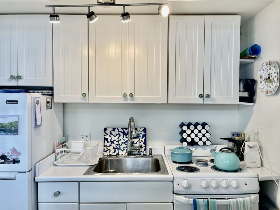 Detail of Kitchen which is fully equipped. Island in front of it has microwave