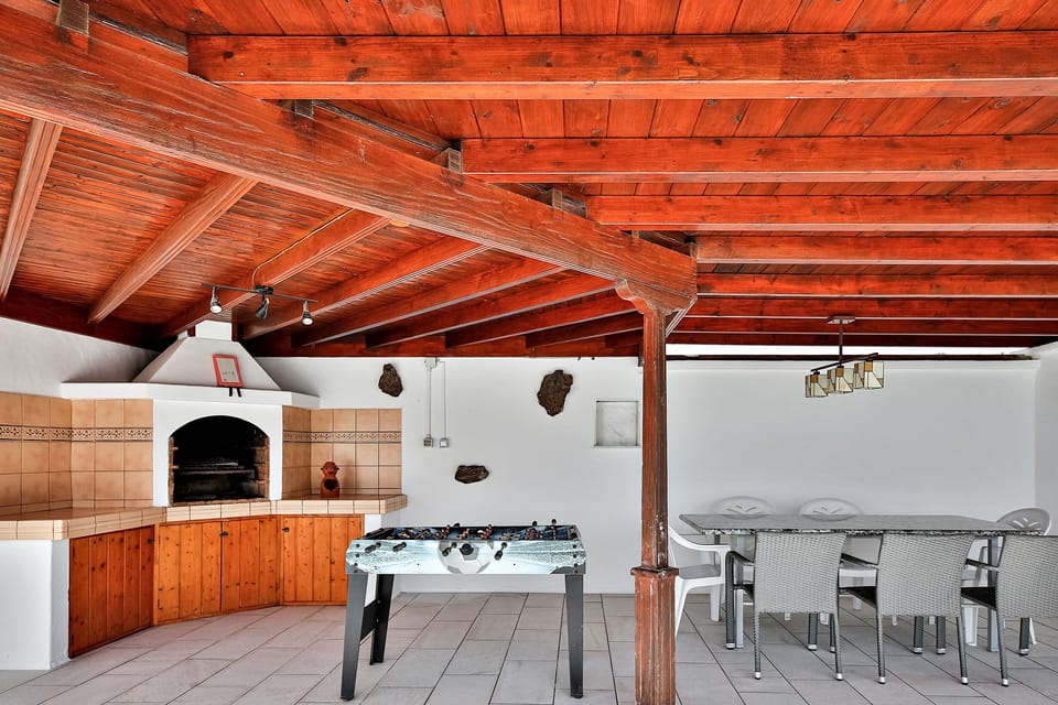 Covered barbeque area with al fresco dining and foozball table