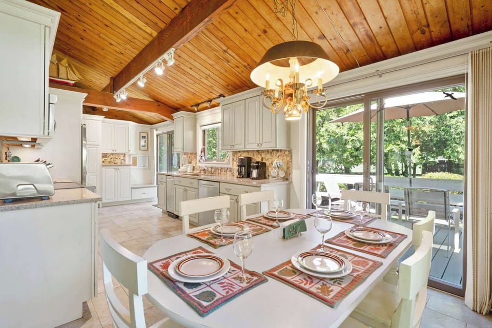 Kitchen and dining area with sliding glass doors to rear deck