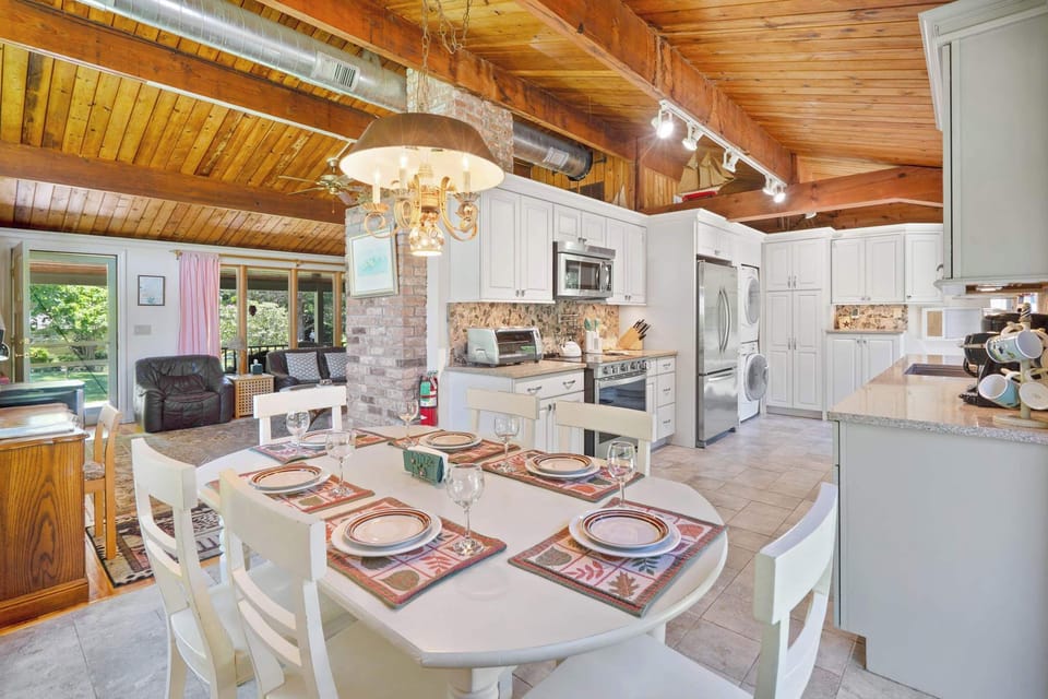 Eat-in kitchen with vaulted wood ceiling and dining table for six