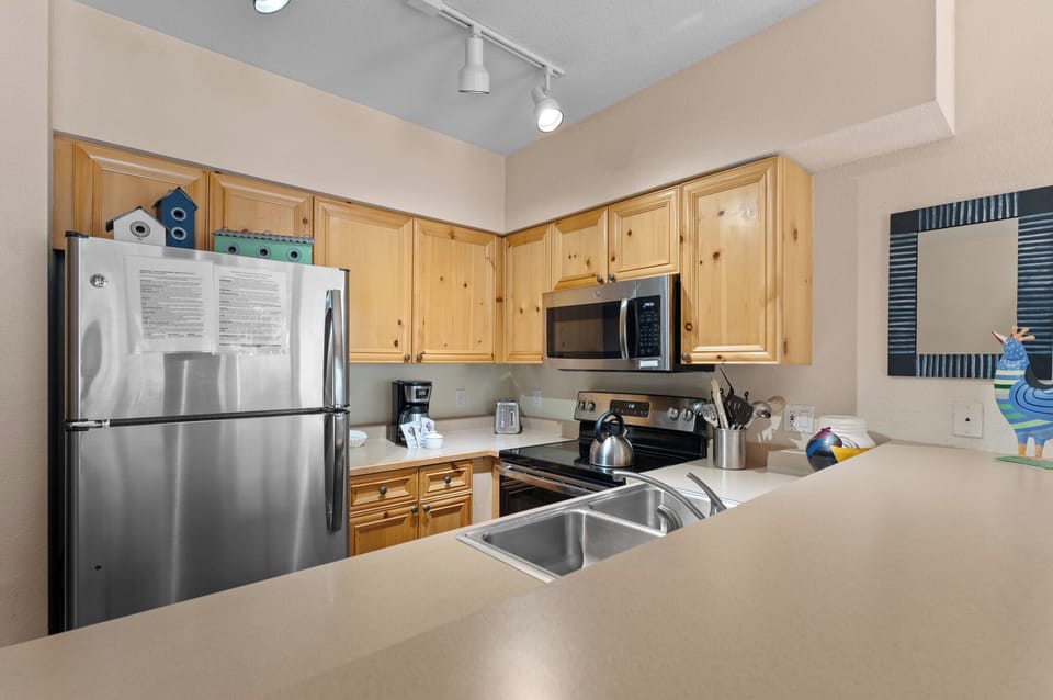 Your spacious kitchen features stainless steel appliances, warm wood cabinetry, and ample counter space for preparing memorable meals together.