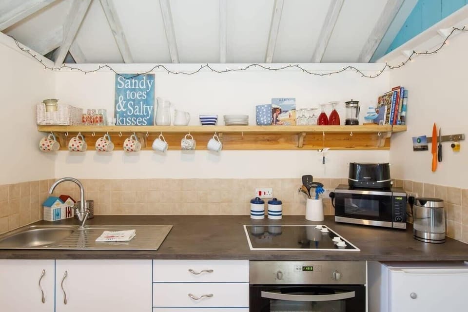 The kitchen has a toaster, kettle, microwave, oven and fridge.