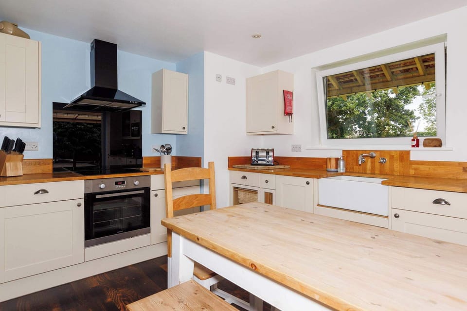 Cook up a feast in the charming, country-style kitchen, complete with modern appliances, wooden countertops, and a large dining area for family meals.