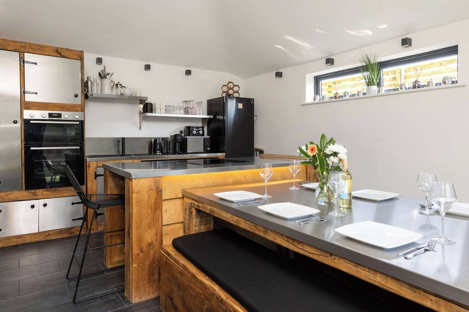 Prepare delicious meals and gather together in this fully-equipped, modern rustic kitchen space.