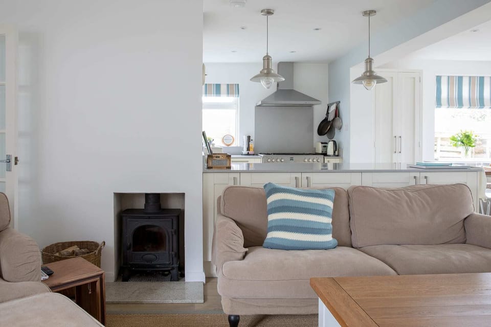 Charming wood-burning fireplace is a perfect gathering point during cold winter nights.