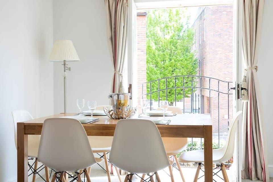 The dining table is set by the Juliet balcony which you can open up on warmer days.