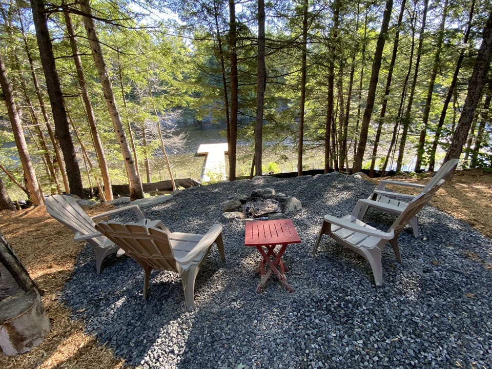 Tranquil fire pit with lake view. Ample complementary firewood on site to enjoy.