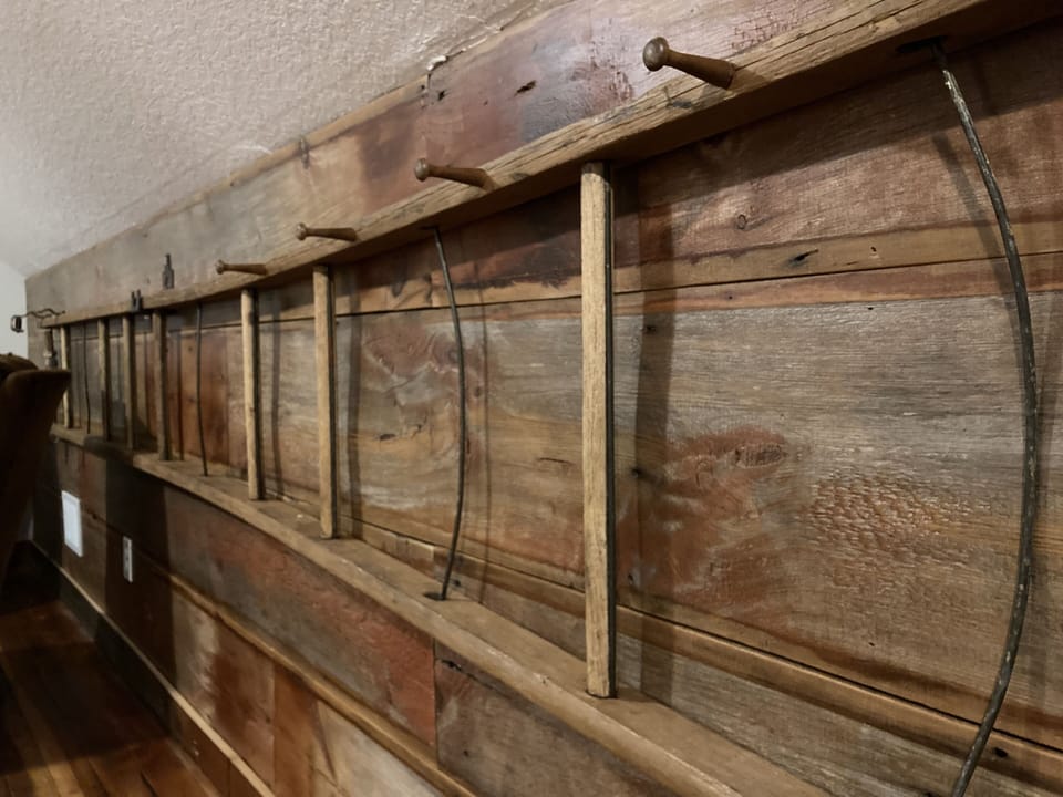 Antique ladder with hooks for clothes.  