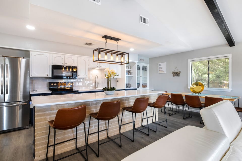 Dining table seats 8, it has a bench seat on one side, with barstools seats 12.