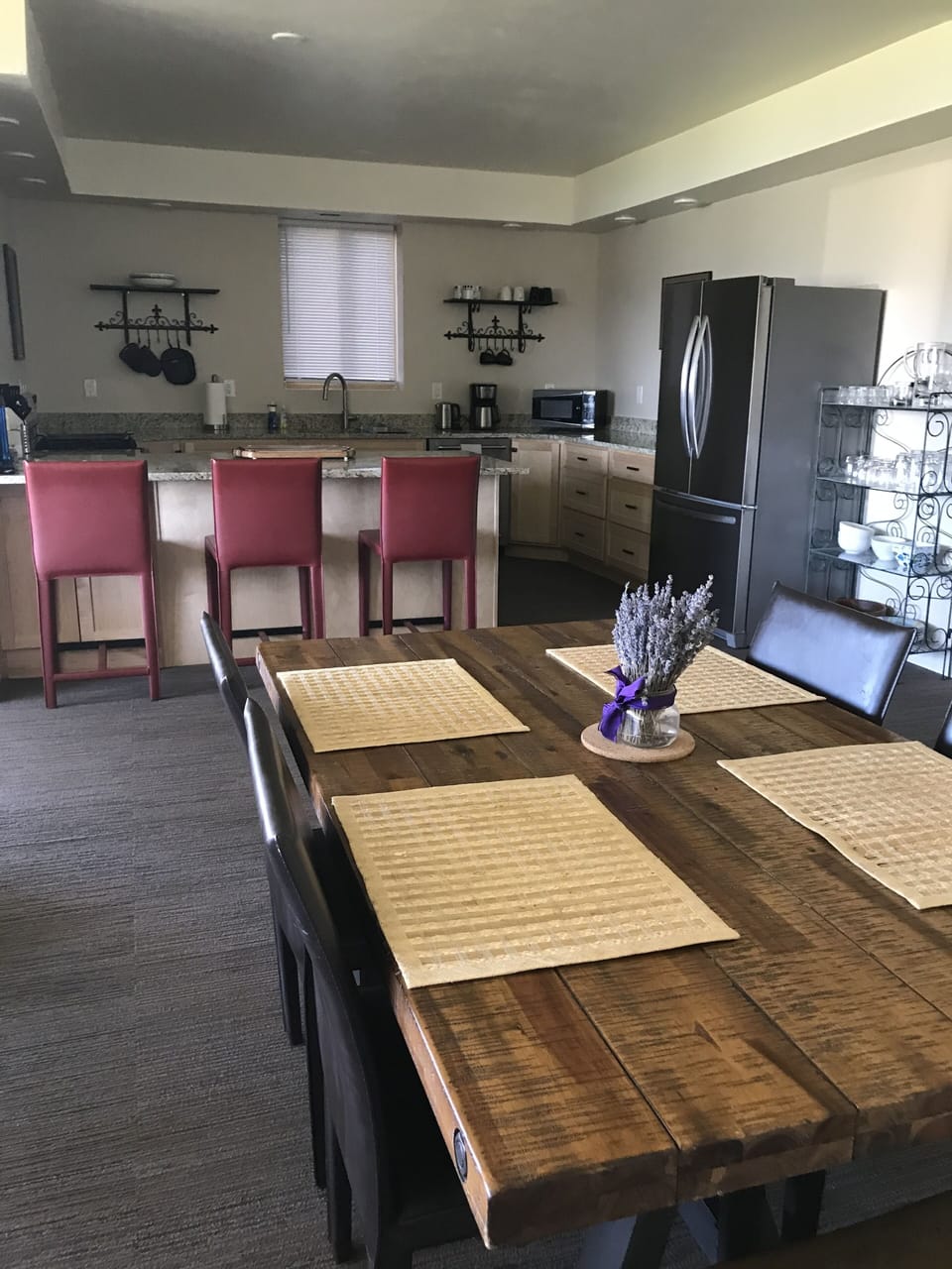 View from dining room table that seats 6 into fully equipped kitchen. 3 stools