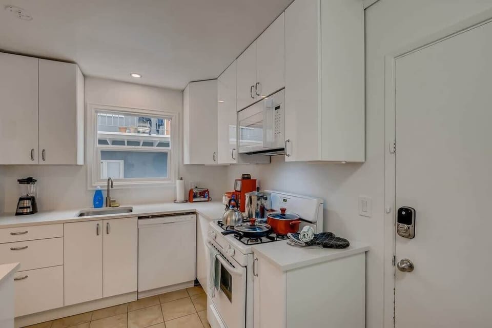 Enjoy the newly remodeled kitchen with private in unit LG washer/dryer, refrigerator, oven, stove, microwave, dishwasher, coffee, creamers, mixers, spices, pots, pans, cooking supplies, cutlery, cups, plates, bowls, utensils, small appliances, and many essentials.
