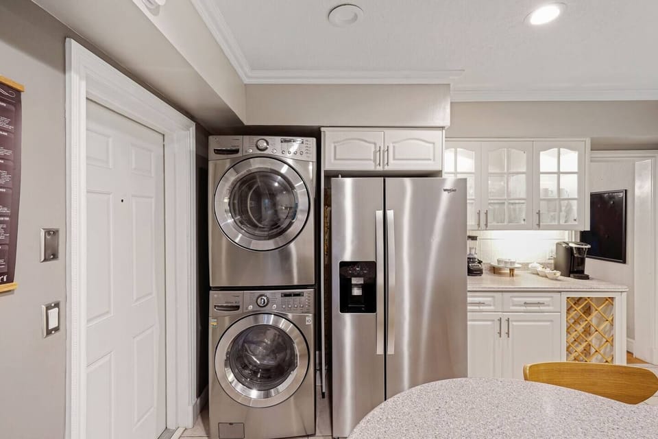 Enjoy the convenience of a fully equipped kitchen featuring modern stainless steel appliances. This space includes a side-by-side refrigerator and an in-unit stacked washer/dryer.
