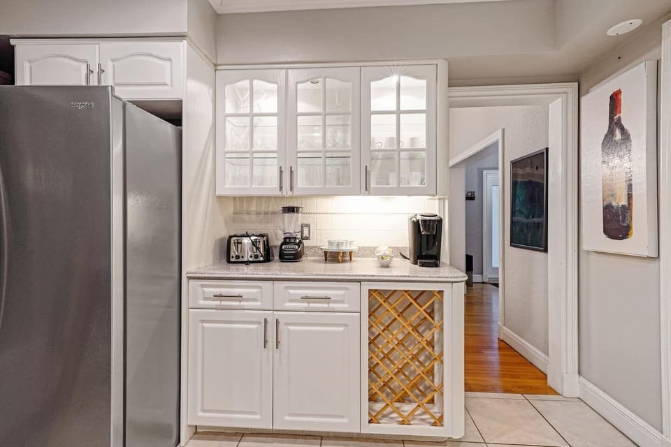 Charming, fully equipped kitchen with bright cabinetry, modern appliances, and a dedicated coffee station, perfect for preparing meals and enjoying a relaxed stay.